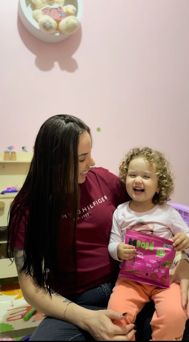 Aline e uma criança em uma cena espontânea de rotina em casa